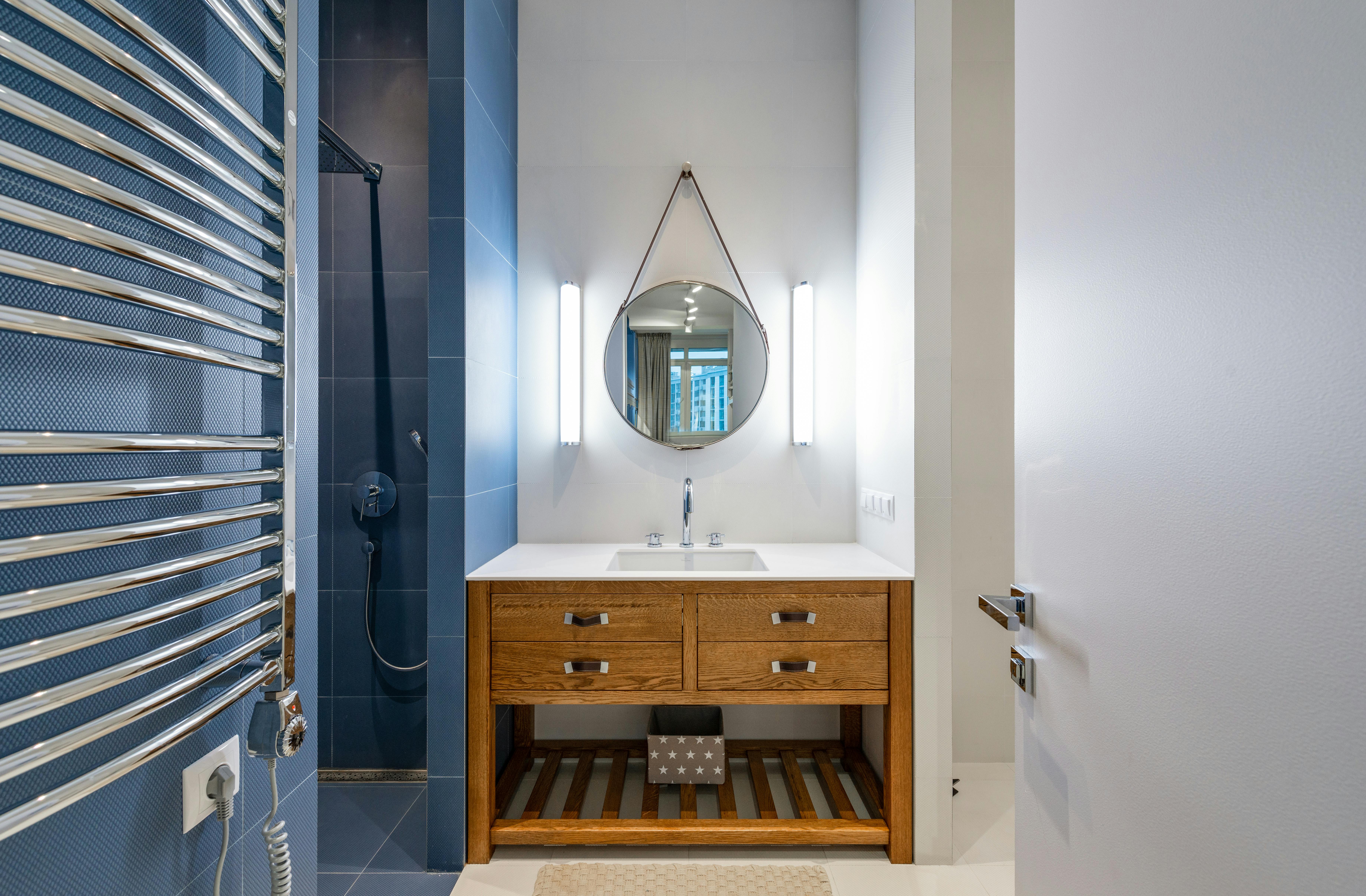 After - Modern wood vanity with round mirror